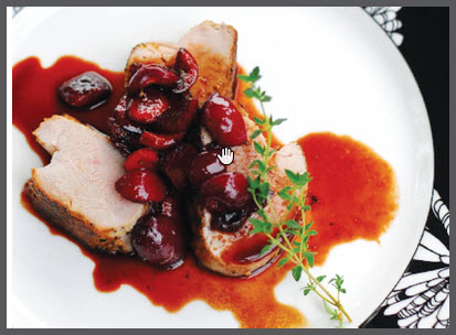 spiced pork tenderloin with cherry thyme sauce on plate