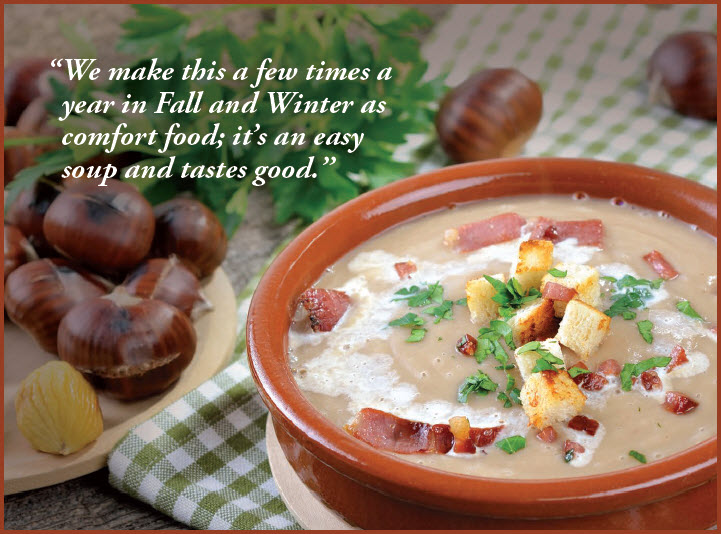 Creamed Chestnut Soup with bacon & crouton topping in red bowl